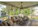 Relaxing screened porch with comfortable seating and view of the backyard at 2828 Wagner Way, Mount Pleasant, SC 29466