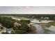 Expansive aerial view showcasing a beautiful home, waterway, and lush surrounding landscape at 2834 Parkers Landing Rd, Mount Pleasant, SC 29466