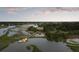 Aerial view of waterfront estate featuring a long private dock and golf course at 2834 Parkers Landing Rd, Mount Pleasant, SC 29466