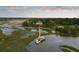 An aerial view showcasing a house with a private dock and waterfront access amid lush surroundings at 2834 Parkers Landing Rd, Mount Pleasant, SC 29466