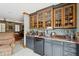 Home bar area featuring glass-front cabinets, granite countertops, and modern appliances at 2834 Parkers Landing Rd, Mount Pleasant, SC 29466