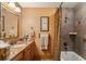 Full bathroom features a tiled shower/tub combo and a wood vanity with decorative elements at 2834 Parkers Landing Rd, Mount Pleasant, SC 29466