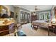 A spacious main bedroom featuring carpet floors, a ceiling fan, an exterior view, and dark wood furniture at 2834 Parkers Landing Rd, Mount Pleasant, SC 29466