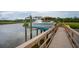 Modern boat on a lift at a private dock, ensuring easy access and maintenance, with scenic marsh views at 2834 Parkers Landing Rd, Mount Pleasant, SC 29466