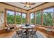 Sun-lit breakfast nook featuring hardwood floors, ceiling fan, and beautiful backyard views at 2834 Parkers Landing Rd, Mount Pleasant, SC 29466
