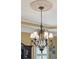 Dining room chandelier hanging from an elegant ceiling medallion with views of the room and windows at 2834 Parkers Landing Rd, Mount Pleasant, SC 29466