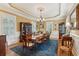 Traditional dining room with hardwood floors, wainscoting, chandelier, and large windows with plantation shutters at 2834 Parkers Landing Rd, Mount Pleasant, SC 29466
