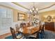 Spacious dining room with a large table, chandelier, hardwood floors, and views into other rooms at 2834 Parkers Landing Rd, Mount Pleasant, SC 29466