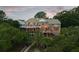 Gorgeous home at dusk featuring a screened in porch and walkway through lush greenery at 2834 Parkers Landing Rd, Mount Pleasant, SC 29466