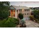 Stately brick home boasts an elegant facade with columns, a metal roof, and lush landscaping at 2834 Parkers Landing Rd, Mount Pleasant, SC 29466