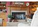 Close-up of the living room fireplace featuring a stone hearth and mantel with decorative accents and flanking bookshelves at 2834 Parkers Landing Rd, Mount Pleasant, SC 29466