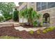 Well-manicured front yard with landscaped garden, mulch beds, and palm tree at 2834 Parkers Landing Rd, Mount Pleasant, SC 29466