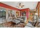 Living room with red walls, open floor plan flowing into the kitchen, and natural light from large windows at 2834 Parkers Landing Rd, Mount Pleasant, SC 29466