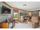 Comfortable living area with plush seating, large window with view, and stylish media cabinet at 2834 Parkers Landing Rd, Mount Pleasant, SC 29466