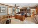 Inviting home office with custom wood built-ins and ample natural light from shuttered windows at 2834 Parkers Landing Rd, Mount Pleasant, SC 29466