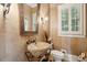 A charming powder room featuring a unique stone sink and a decorative mirror at 2834 Parkers Landing Rd, Mount Pleasant, SC 29466