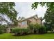 Charming rear exterior of home featuring brick, a screened porch, and a well-maintained yard with mature trees at 2834 Parkers Landing Rd, Mount Pleasant, SC 29466