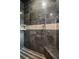 Shower with dark and light brown tiles, built in shelving, and mounted shower head at 2834 Parkers Landing Rd, Mount Pleasant, SC 29466
