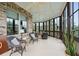 A relaxing sun room with wicker chairs, brick accents and many large glass windows at 2834 Parkers Landing Rd, Mount Pleasant, SC 29466