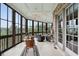 Relax in this sun room with large glass windows and a light ceiling fan for a comfortable breeze at 2834 Parkers Landing Rd, Mount Pleasant, SC 29466