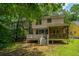 Charming backyard view featuring a deck, covered porch, lush greenery, and mature trees at 3005 Macbeth Creek Dr, Charleston, SC 29414