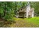 A lush backyard featuring a deck, covered porch, and mature trees at 3005 Macbeth Creek Dr, Charleston, SC 29414