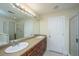 Bathroom features a large mirror, double vanity and shower with glass doors at 3005 Macbeth Creek Dr, Charleston, SC 29414