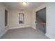 Upstairs hallway features carpet, white trim, a large window with blinds and view of the stairs at 3005 Macbeth Creek Dr, Charleston, SC 29414