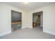 Upstairs hallway features carpet, white trim, a view of the stairs, and a doorway to another room at 3005 Macbeth Creek Dr, Charleston, SC 29414