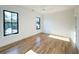 Bright bedroom featuring hardwood floors, two large windows, and a ceiling fan at 3898 Summerton Street Dr, Mount Pleasant, SC 29466