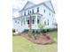 Charming two-story home with a welcoming front porch and beautifully landscaped front yard at 3898 Summerton Street Dr, Mount Pleasant, SC 29466