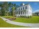 Elegant two-story home boasts a spacious front porch and lush landscaping at 3898 Summerton Street Dr, Mount Pleasant, SC 29466