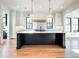 Spacious kitchen with island, stainless steel refrigerator and pendant lighting at 3898 Summerton Street Dr, Mount Pleasant, SC 29466