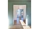 Sunlit living room with light green walls, hardwood floors and an open doorway at 3898 Summerton Street Dr, Mount Pleasant, SC 29466