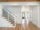 Inviting living room with hardwood floors, staircase, and a view into the foyer and entry door at 3898 Summerton Street Dr, Mount Pleasant, SC 29466