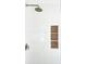 Modern shower with white tiled walls, bronze fixtures, and decorative tiled shelves at 3898 Summerton Street Dr, Mount Pleasant, SC 29466