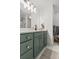 Bathroom featuring a green vanity with a marble countertop, a mirror, and tiled floors at 4 Beaufain St # 207, Charleston, SC 29401