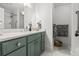 Bathroom featuring a green vanity with a marble countertop, a mirror, and tiled floors at 4 Beaufain St # 207, Charleston, SC 29401