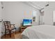 Bedroom with a television, a window with blinds, and a chair at 4 Beaufain St # 207, Charleston, SC 29401