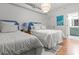 Inviting bedroom features two beds, hardwood floors and ensuite bathroom at 4 Beaufain St # 207, Charleston, SC 29401