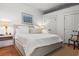 Bright bedroom with a large bed, white linens, and a textured rug at 4 Beaufain St # 207, Charleston, SC 29401