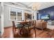 Dining area with a wood table, views of the street, living room, and stylish artwork at 4 Beaufain St # 207, Charleston, SC 29401