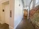 Hallway with exposed brick, elevator access, and natural light from nearby windows at 4 Beaufain St # 207, Charleston, SC 29401