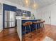 Modern kitchen with stainless steel appliances, blue cabinetry, and a waterfall island with bar seating at 4 Beaufain St # 207, Charleston, SC 29401