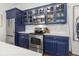 Well-equipped kitchen with blue cabinets, stainless steel appliances, and a white marble backsplash at 4 Beaufain St # 207, Charleston, SC 29401