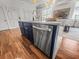Kitchen island with marble countertop, gold faucet, and stainless steel dishwasher, adding function and beauty to the kitchen at 4 Beaufain St # 207, Charleston, SC 29401