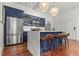Modern kitchen with stainless steel appliances, blue cabinetry, and a waterfall island with bar seating at 4 Beaufain St # 207, Charleston, SC 29401
