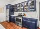 Modern kitchen with stainless steel appliances, sleek countertops, and blue cabinets, providing a stylish cooking space at 4 Beaufain St # 207, Charleston, SC 29401