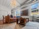 Bright living room with brown leather sofa and unique motorcycle art at 4 Beaufain St # 207, Charleston, SC 29401