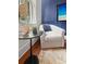 Comfortable sitting area with a plush chair, side table, and a beach scene displayed on the TV at 4 Beaufain St # 207, Charleston, SC 29401